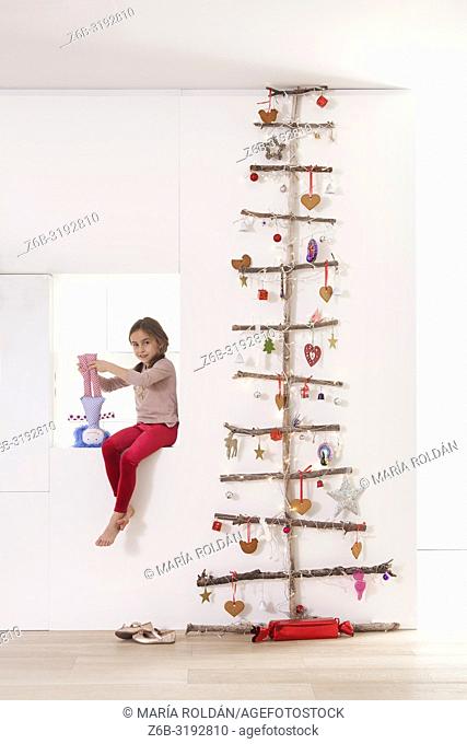 Unique Christmas tree and little girl