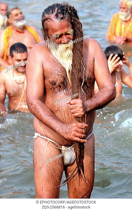 Sadhu in loin cloth bathing. Kumbh Mela, Nasik, Maharashtra, India