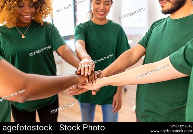 close up of volunteers stacking hands