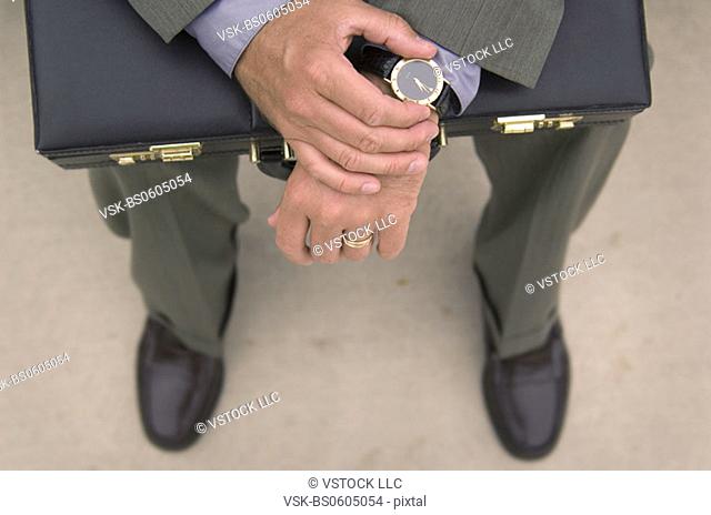 Businessman with Businessman with briefcase checking his watch