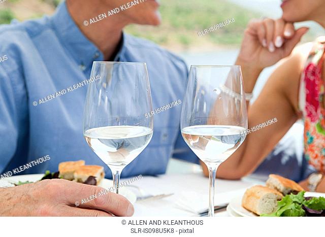 Senior couple having lunch on a boat holiday