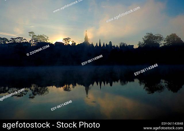 landscape of Pedagogical college of Da Lat view from Xuan Huong lake, beautiful landscape reflect on water, bell tower rise from pine forest