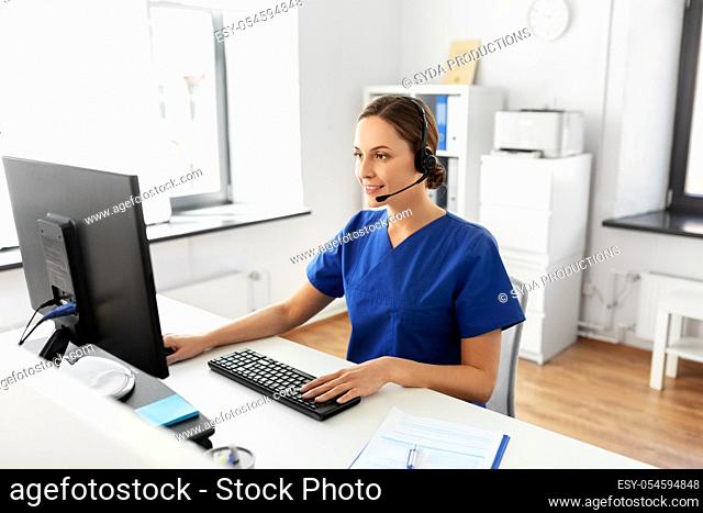 doctor with headset and computer at hospital