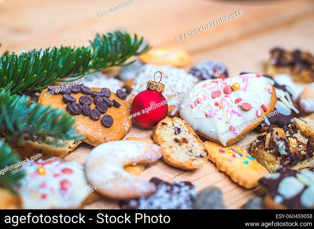 Homemade Christmas cookies, powdered sugar and Christmas bauble on a rustic wooden table