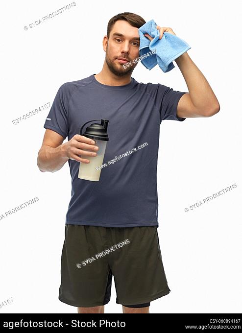 tired man in sports clothes with bottle and towel