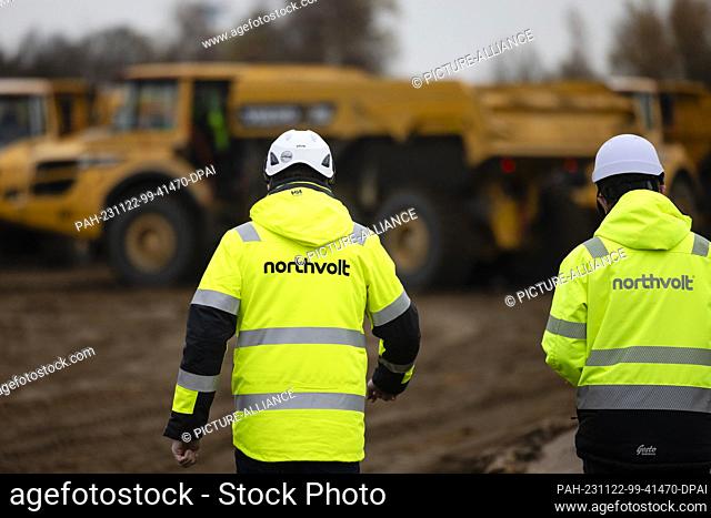 22 November 2023, Lower Saxony, Heide: Two Nothvolt employees walk across a construction site in the Dithmarschen district