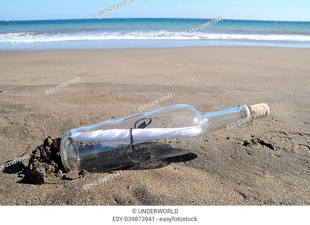 Message in a bottle on a lonely beach , in Tenerife, Spain
