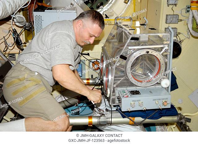 Russian cosmonaut Fyodor Yurchikhin, Expedition 24 flight engineer, prepares the Russian Glavboks-S (Glovebox) for the bioscience experiment ASEPTIC (BTKh-39)...