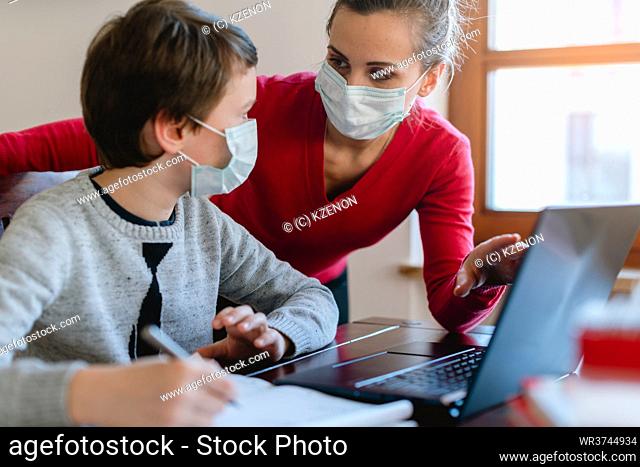 Mother and son in video chat with school teacher wearing masks