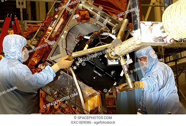 01/29/2002 - Workers in the Vertical Processing Facility maneuver the replacement Reaction Wheel Actuator for the Hubble Space Telescope into position on the...