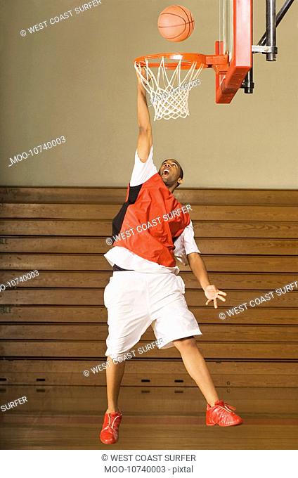 Basketball player missing slam dunk