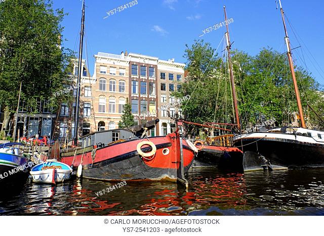 Houseboats moored along Amsterdam canals, The Netherlands, Europe