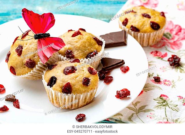 Muffins with cherry on a blue wooden background, horizontal