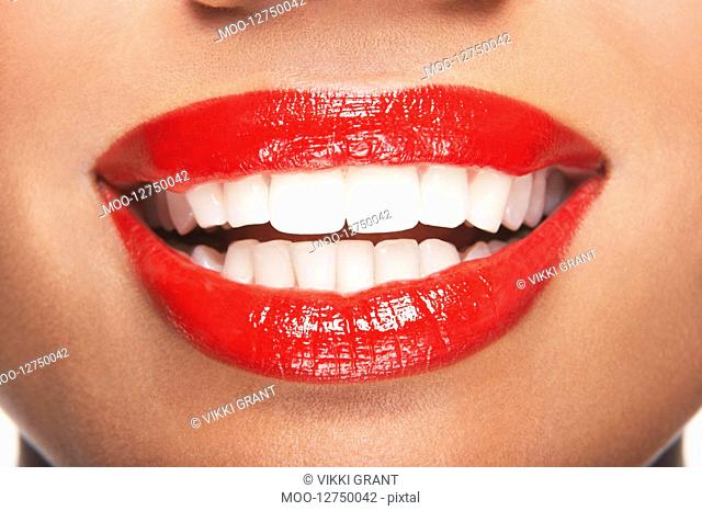 Woman's teeth and mouth with red lipstick