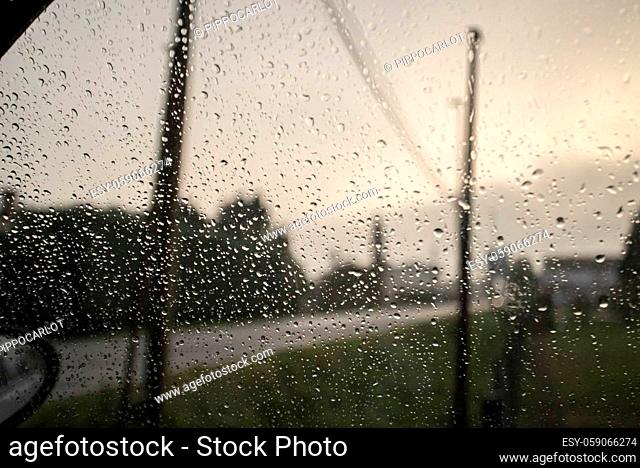 Detail of rain drops falling on the car window