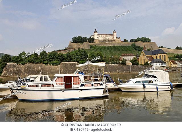 Motorboats on the Main river and behind the fortress of Marienberg, Wuerzburg, Bavaria, Germany