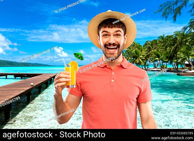 happy man in straw hat with orange juice cocktail