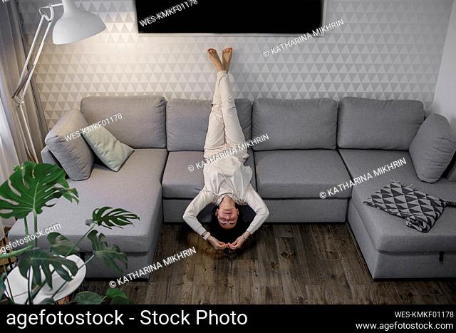Woman relaxing upside down on the couch