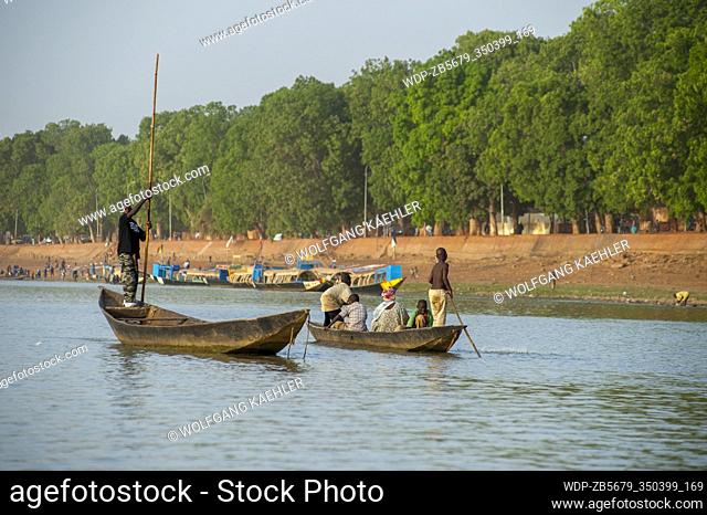 Local people traveling in wooden canoes on the Bani River in Mopti in Mali, West Africa