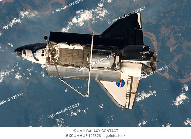 Backdropped by a colorful part of Earth, Space Shuttle Discovery (STS-128) is featured in this image photographed by an Expedition 20 crew member on the...