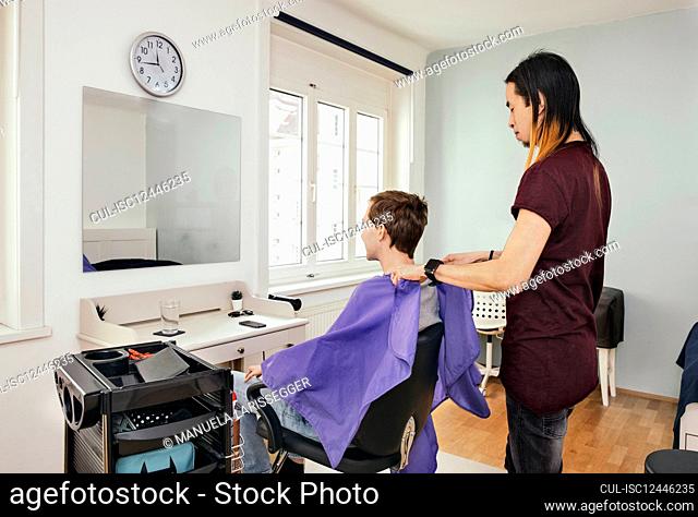 Hairdresser with client in hair salon