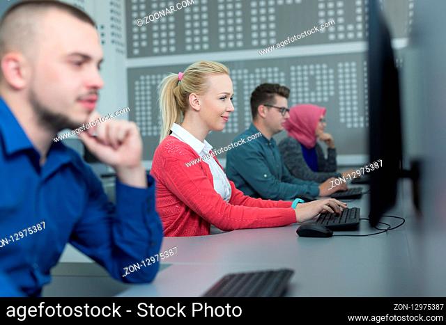 Image of smart people sitting at the tables at computer class
