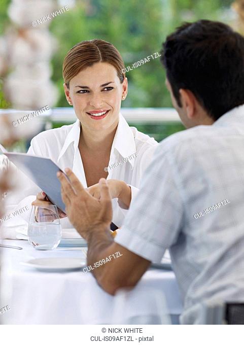 Couple choosing from menu in hotel restaurant