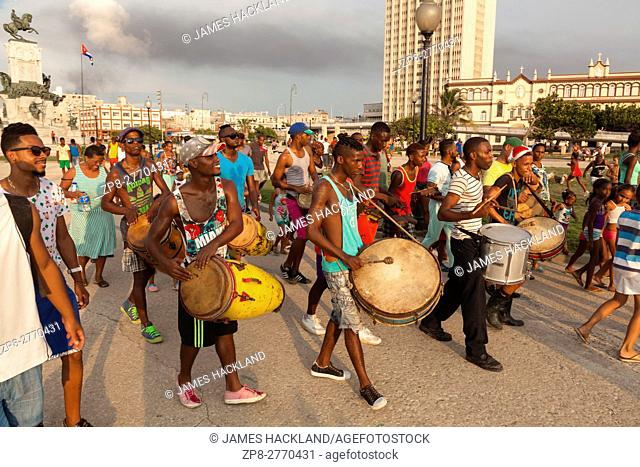 A group of musicians moving through Antonio Maceo Park in Central Havana, Cuba
