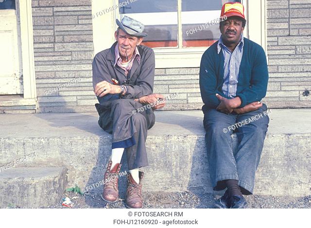Two men down on their luck sitting on a bench