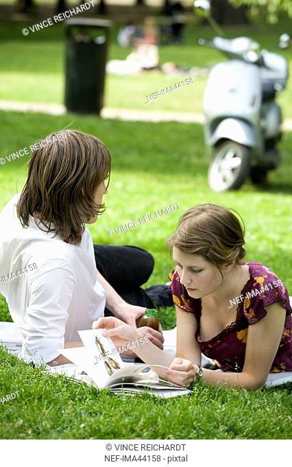 Young Scandinavian couple sitting in a park Sweden