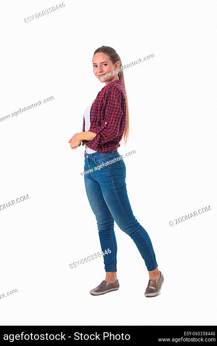 Full length portrait of young woman standing isolated on white background, casual people