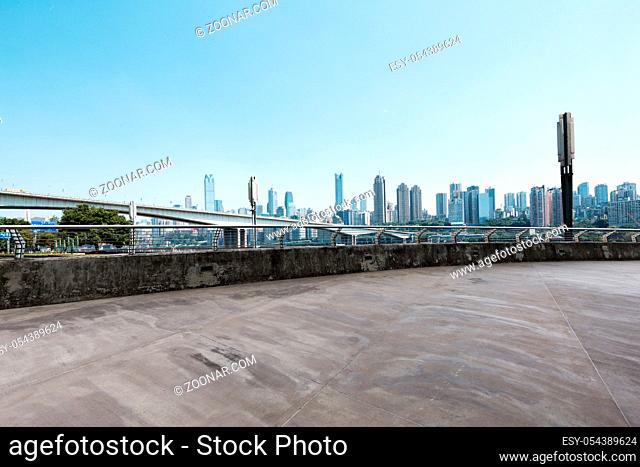 empty concrete road and cityscape of chongqing in blue sky