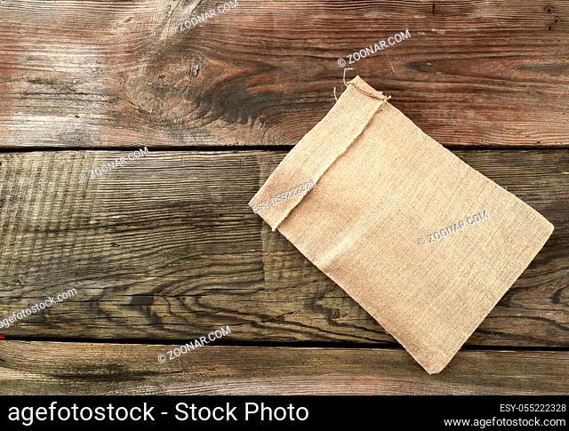 empty canvas gray bag on a wooden background from boards, top view