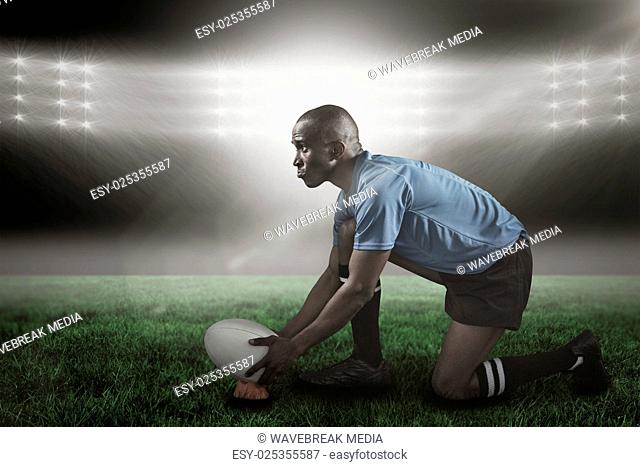 Composite image of confident rugby player looking away while keeping ball on kicking tee 3d