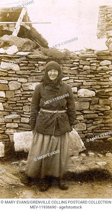 A Local Woman of the Orkney Islands outside her house. Orkney was the site of a Royal Navy base at Scapa Flow, where the sailor who sent this card was stationed...