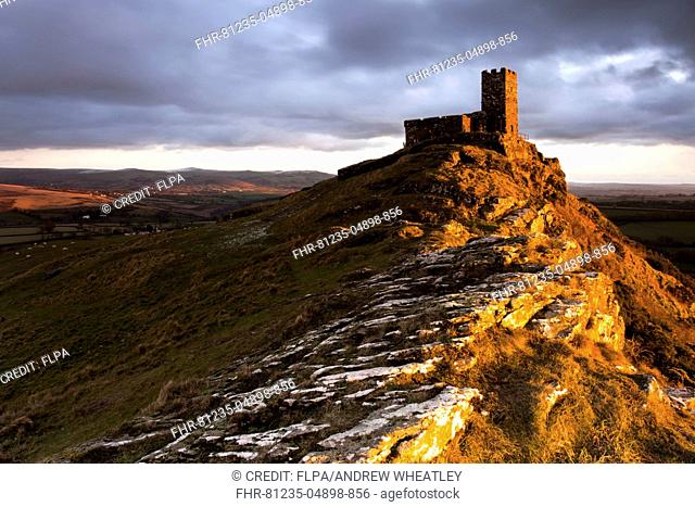 View of basaltic tor with church on summit at sunset, Church of St. Michael, Brent Tor, Dartmoor N.P., Dartmoor, Devon, England, January