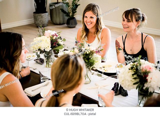 Women enjoying friendship and meal in yoga retreat