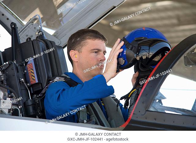 NASA astronaut Reid Wiseman, Expedition 40 flight engineer, prepares for a flight in a NASA T-38 jet trainer at Ellington Airport as he and his crewmates...