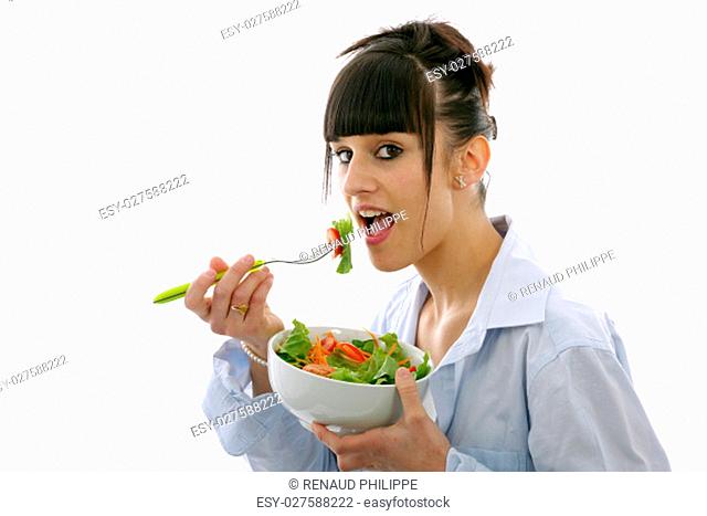 pretty young brunette woman eats salad