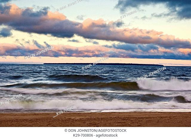 Morning skies over waves crashing on beach of Agawa Bay in Lake Superior, Canada