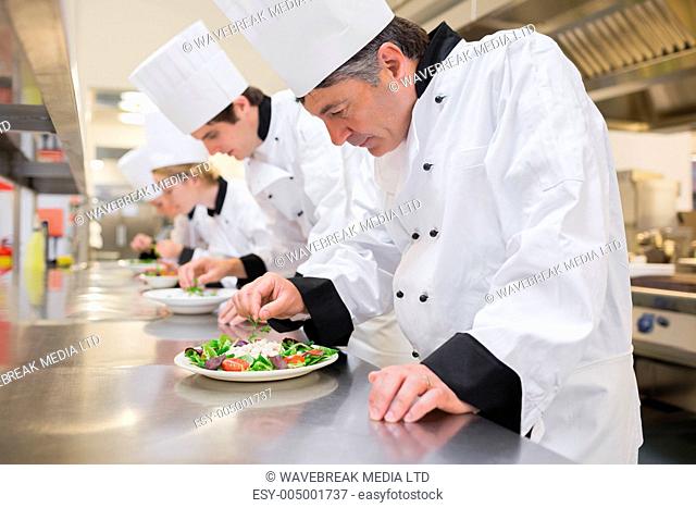 Chefs preparing their salads in the kitchen