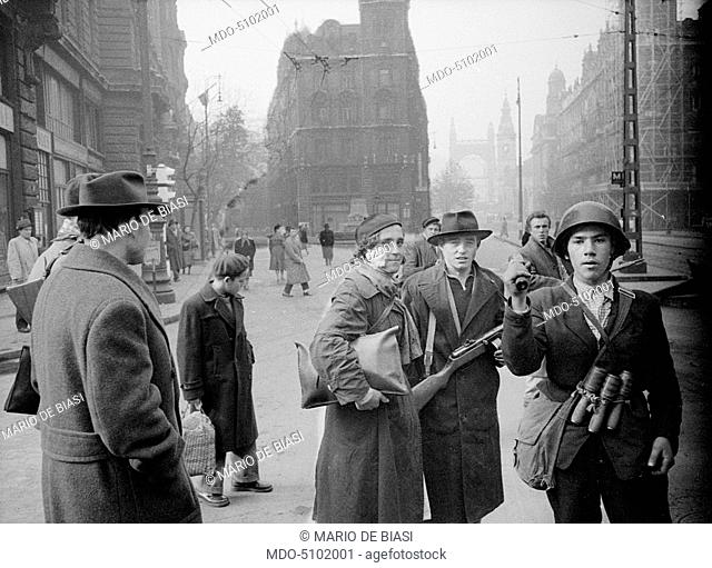 Hungarian revolution of 1956. Two young revolutionaries in the streets of the city during the uprising agianst the Soviet regime: Julia Sponga (with a helmet...