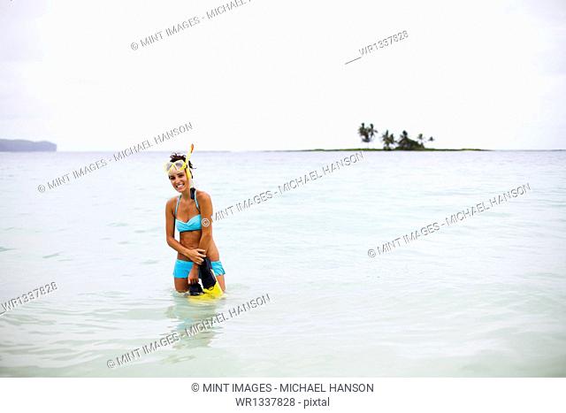 A young woman wades in shallow water on the Samana Peninsula in the Dominican Republic