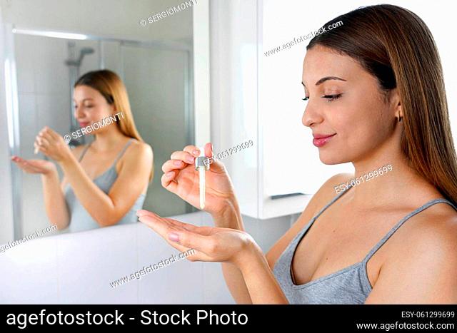 Skin Care Routine. Beautiful woman holding a pipette in her hand with serum moisturizing anti aging antioxidant