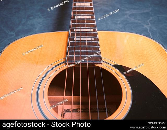 acoustic guitar on blue marble background, music concept