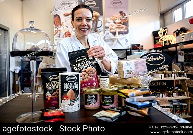 PRODUCTION - 12 December 2023, Berlin: Employee and Head of Marketing Janine Judetzki stands behind products in the store of Neukölln-based marzipan...