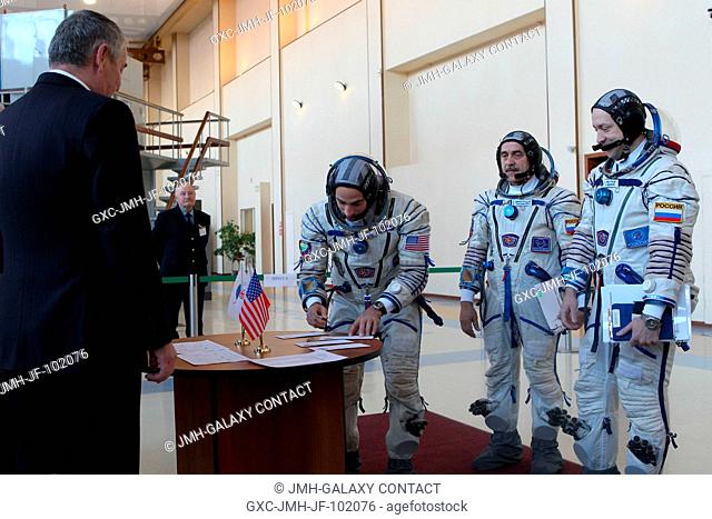 At the Gagarin Cosmonaut Training Center in Star City, Russia, Expedition 3536 Flight Engineer Chris Cassidy of NASA (second from left) signs a book before...