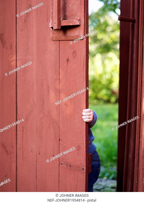 Child behind gate