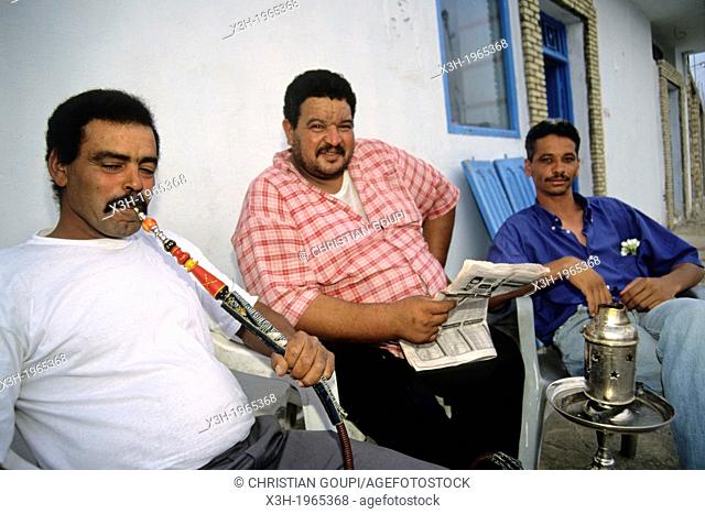 narghile smoker at the terrace of a cafe in Tozeur, Tunisia, North Africa