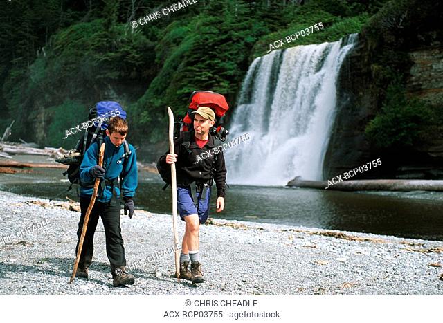 West Coast Trail - hikers at Tsusiat Falls, Vancouver Island, British Columbia, Canada